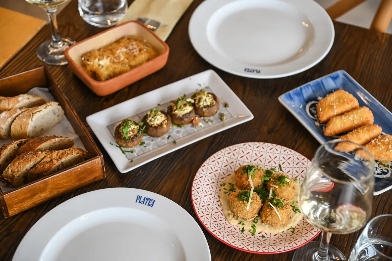 Painted serving plates holding meze in the centre of the table