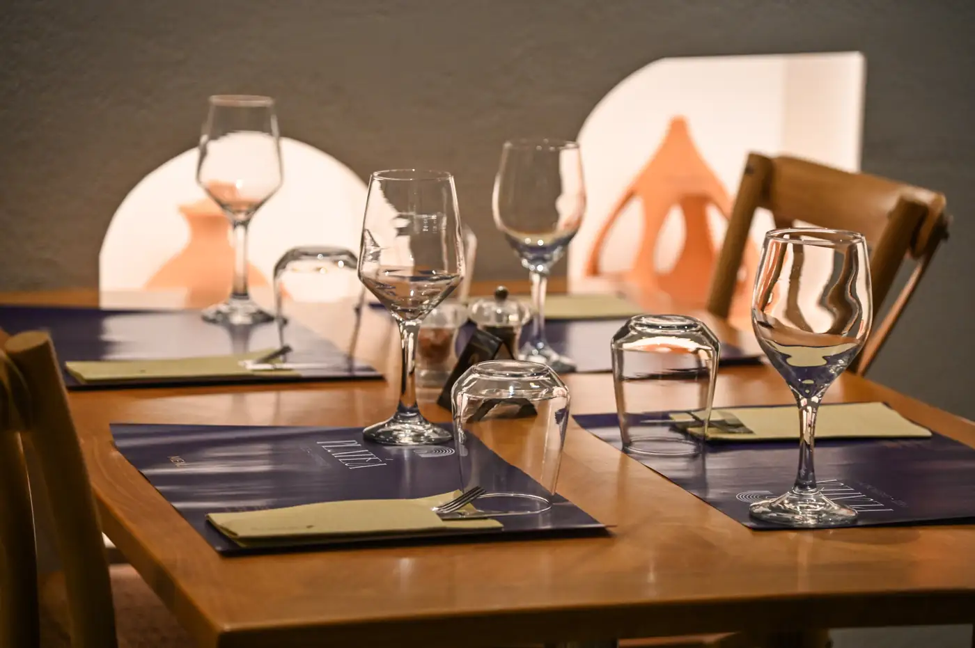 Glassware on a set table by candlelight